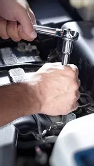 mechanic repairing a car with a wrench