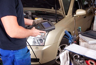 CAR WHEEL ALIGNMENT AND BALANCING Watford and Hertfordshire - mechanic inspecting vehicle wheel alignment